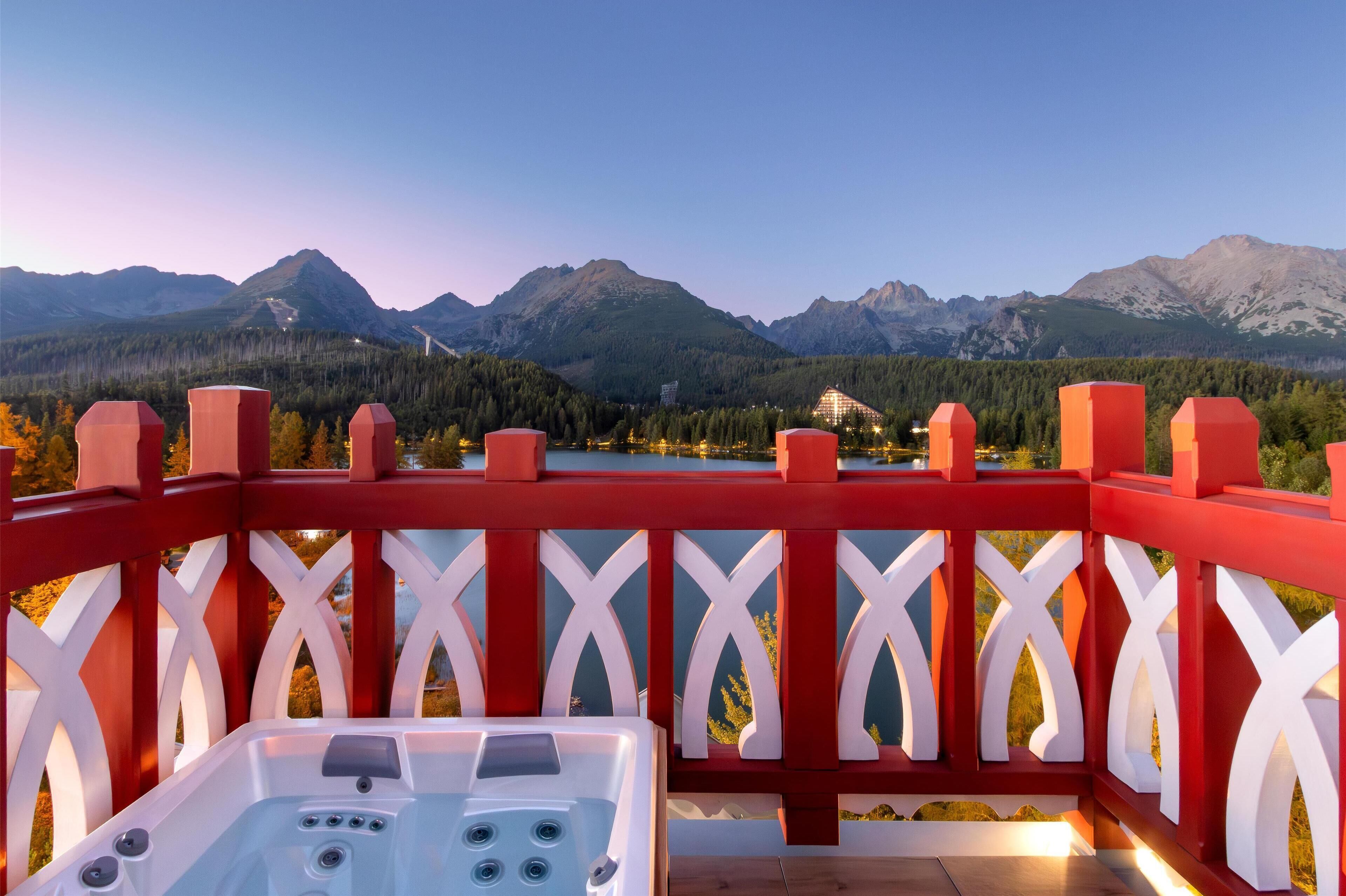 A hot tub on a balcony with a mountain view.