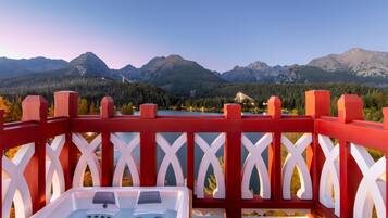A hot tub on a balcony with a mountain view.