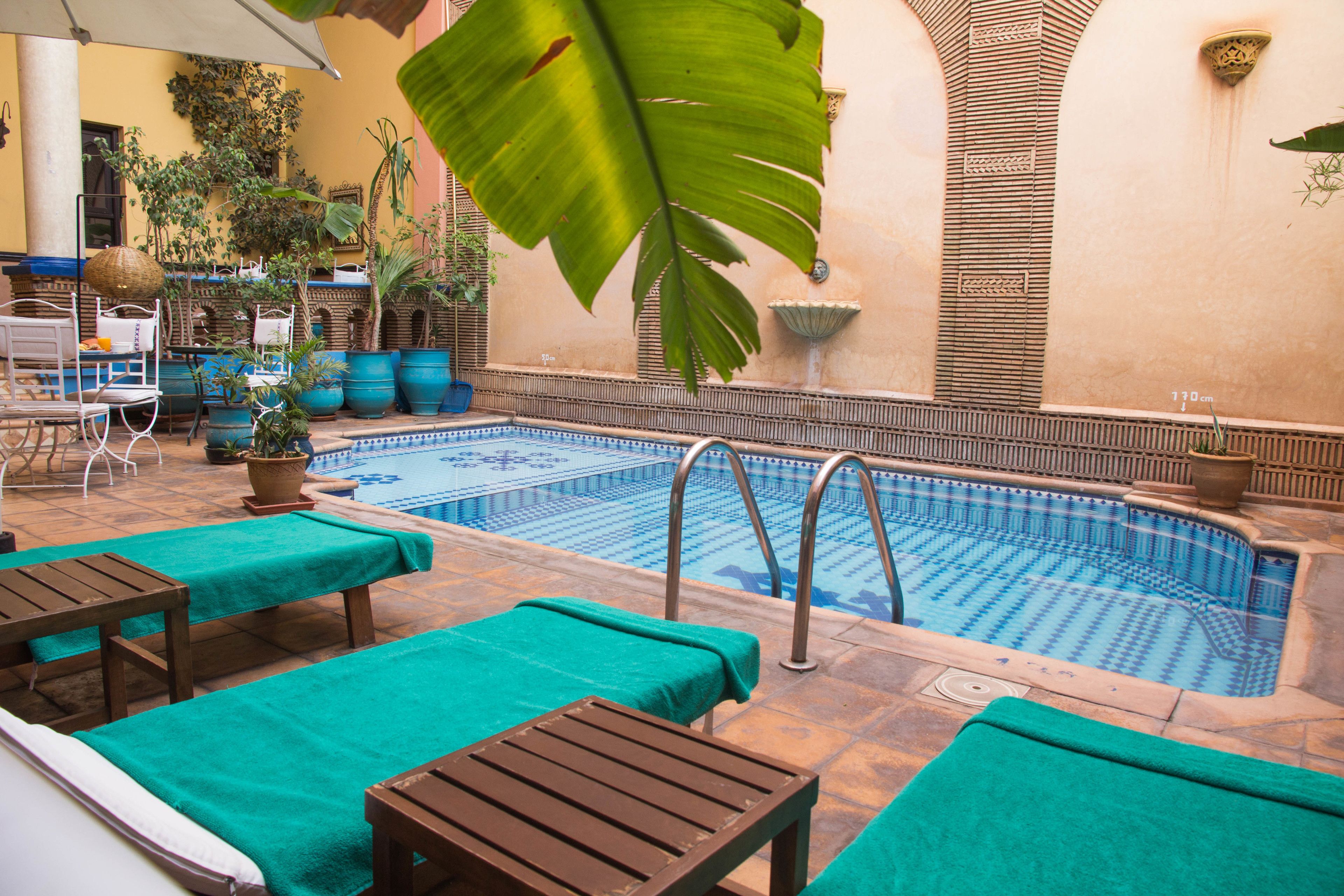 outdoor pool, open 9:00 am to 7:00 pm, pool umbrellas, pool loungers