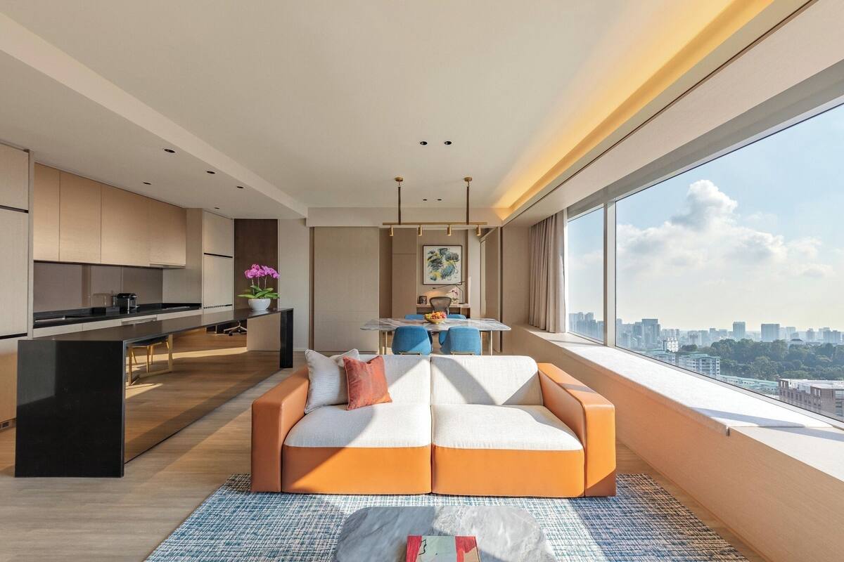 A modern apartment with a kitchen, dining area, and a large window with a city view.