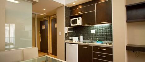 Fridge, microwave, coffee/tea maker, cookware/dishes/utensils