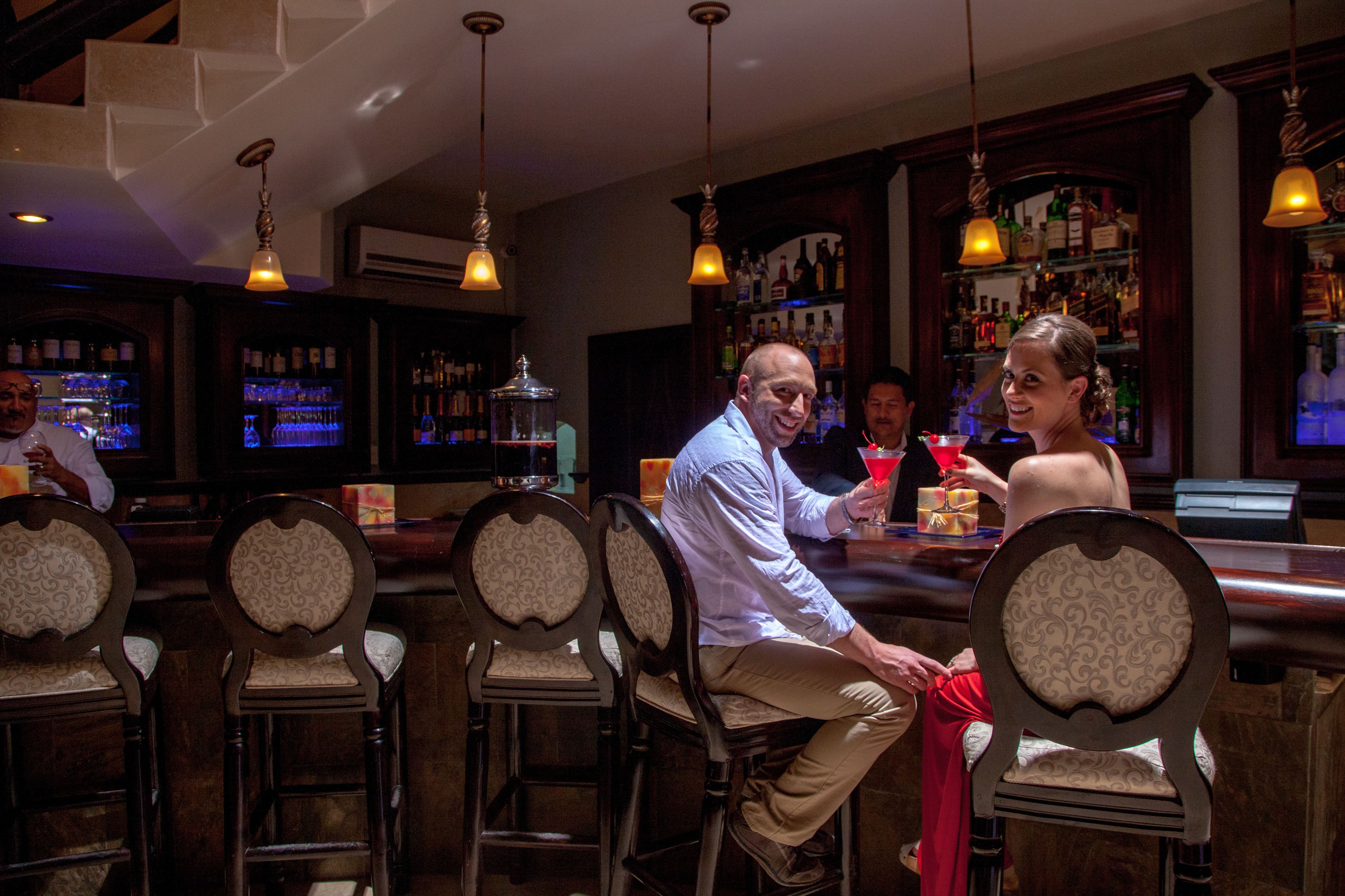 A bar area with wooden chairs and a bar counter.