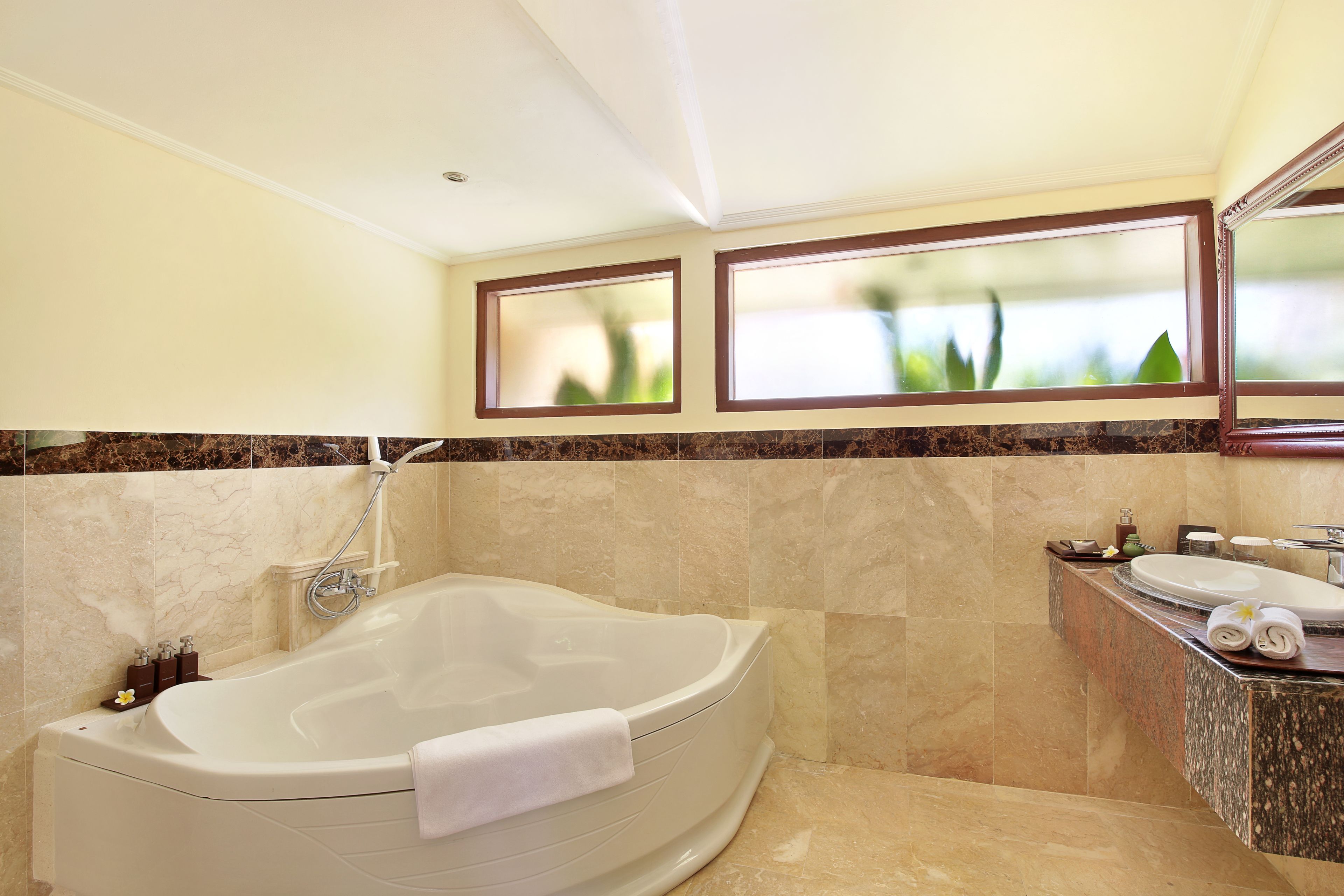 A modern bathroom with a freestanding bathtub, a vanity with a sink, and a mirror above the mirror.
