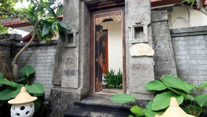 A traditional building with a stone entrance, steps leading up to it, and two decorative lanterns on either side. - The Grand Bali Nusa Dua (Nusa Dua)