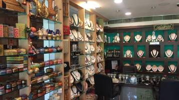 A jewelry store with glass display cases and shelves filled with various jewelry items.