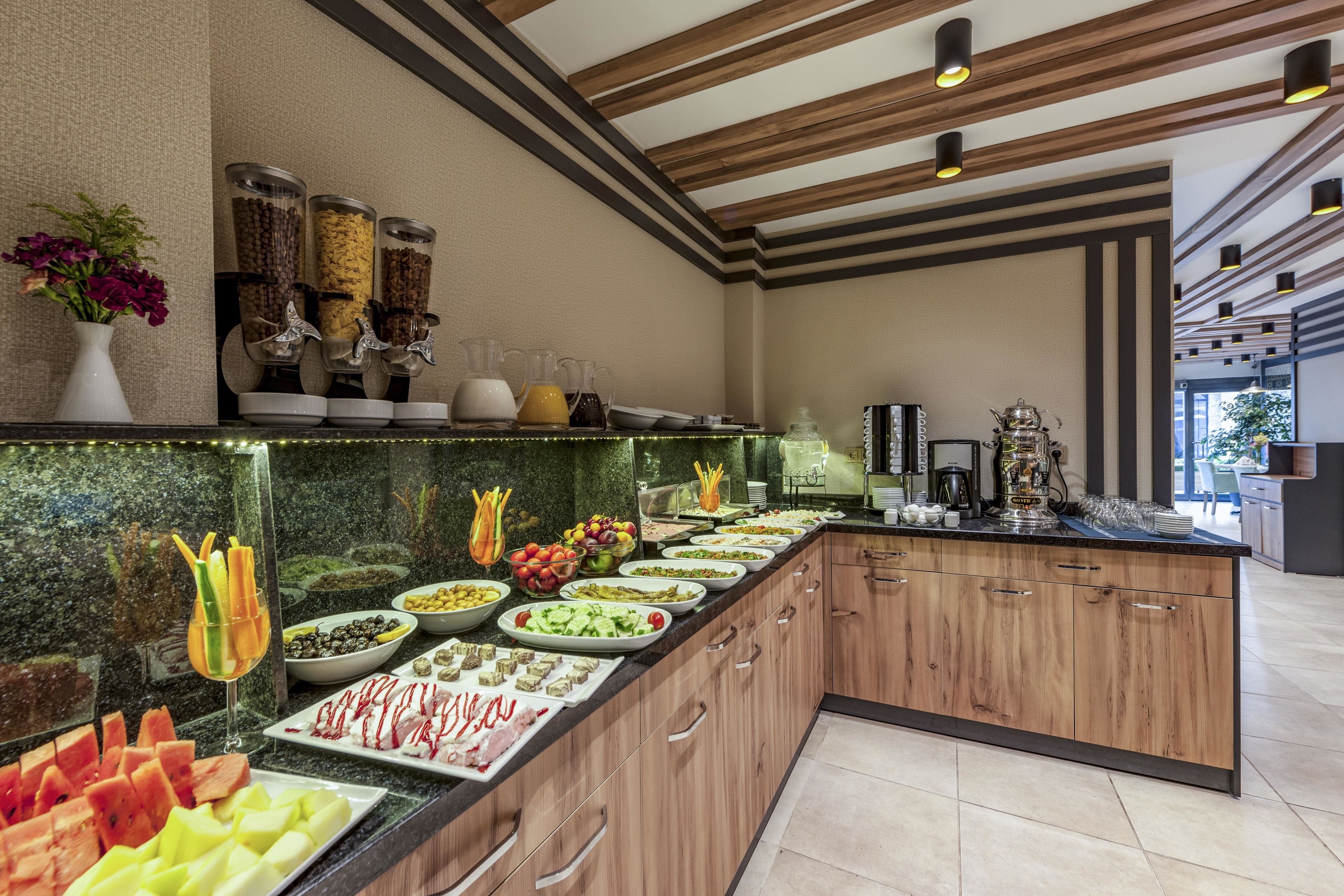 A buffet with various food items and condiments.