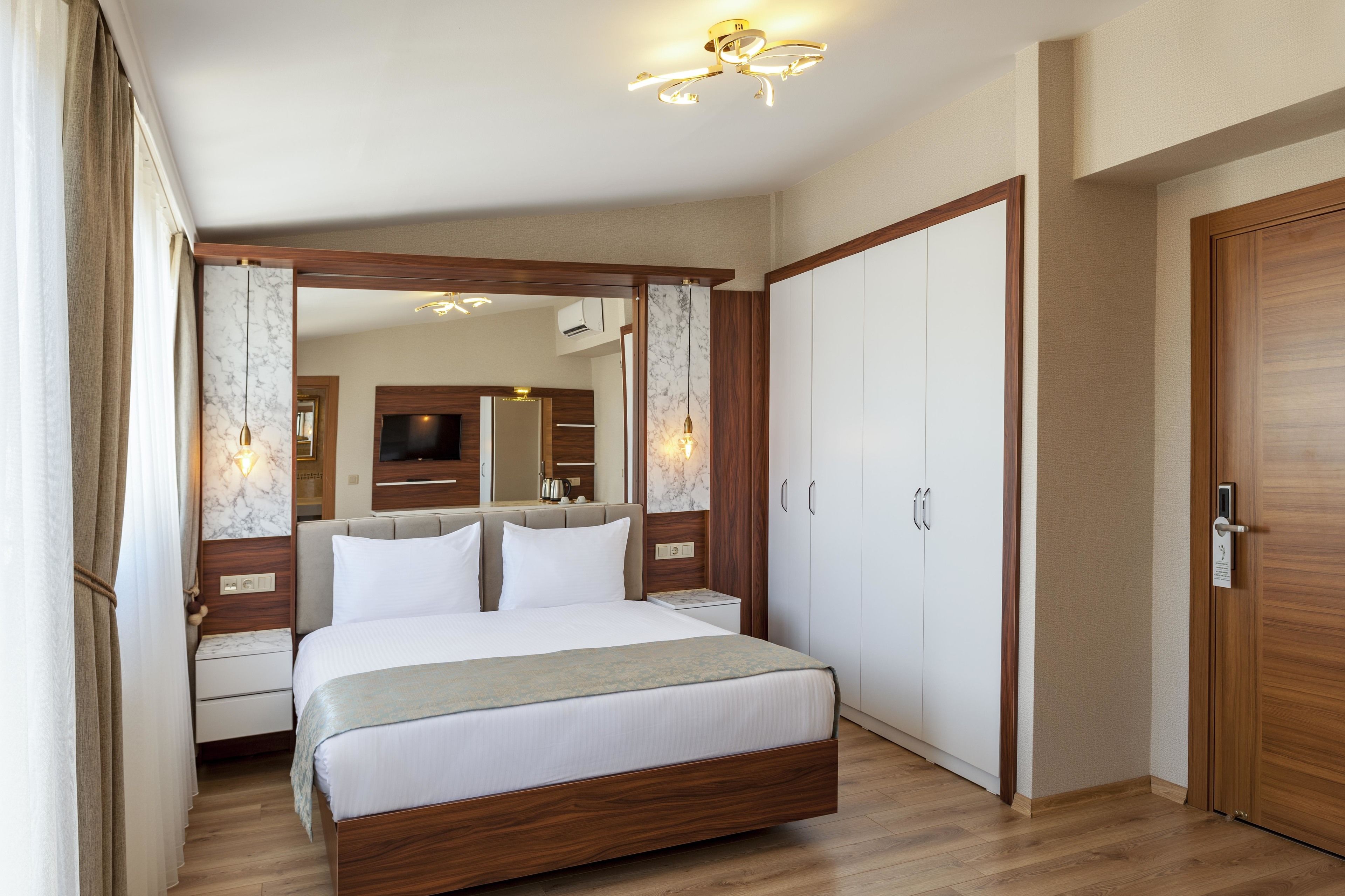 Un dormitorio con una cama grande, armario de madera y un espejo.