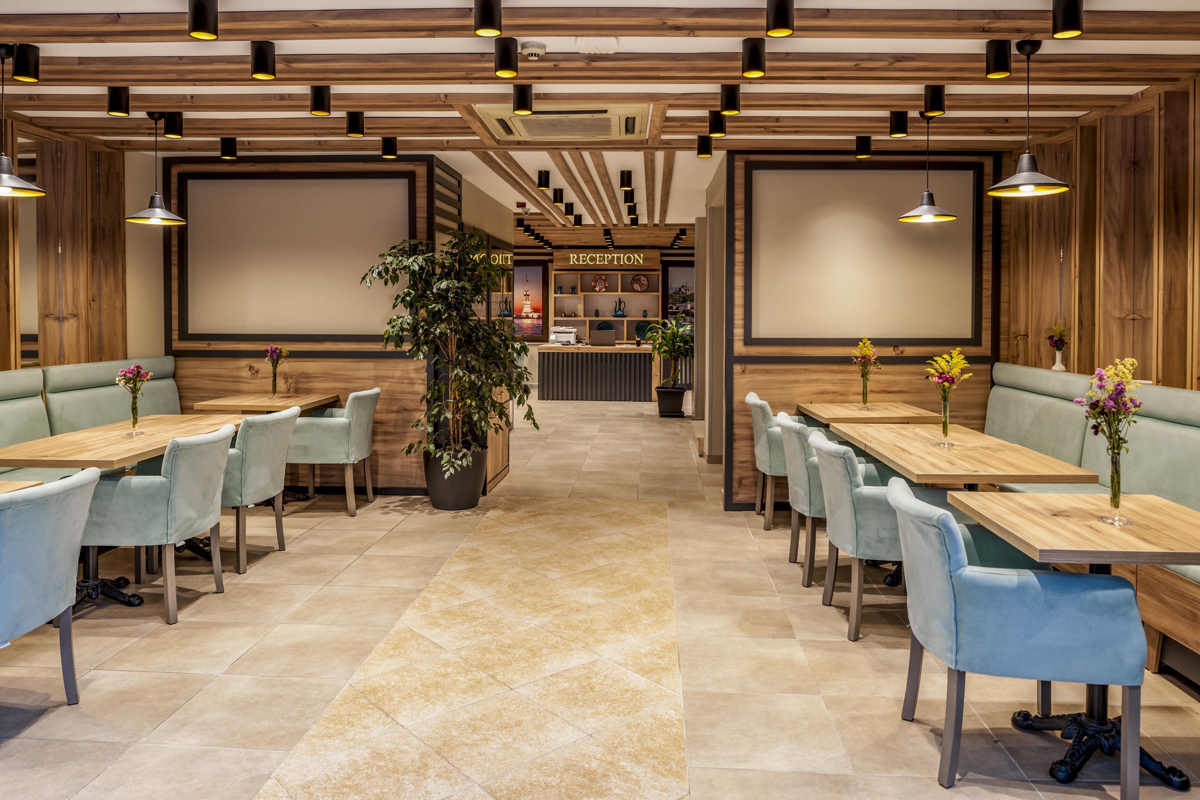 A reception area with a reception desk, seating arrangements, and a plant.