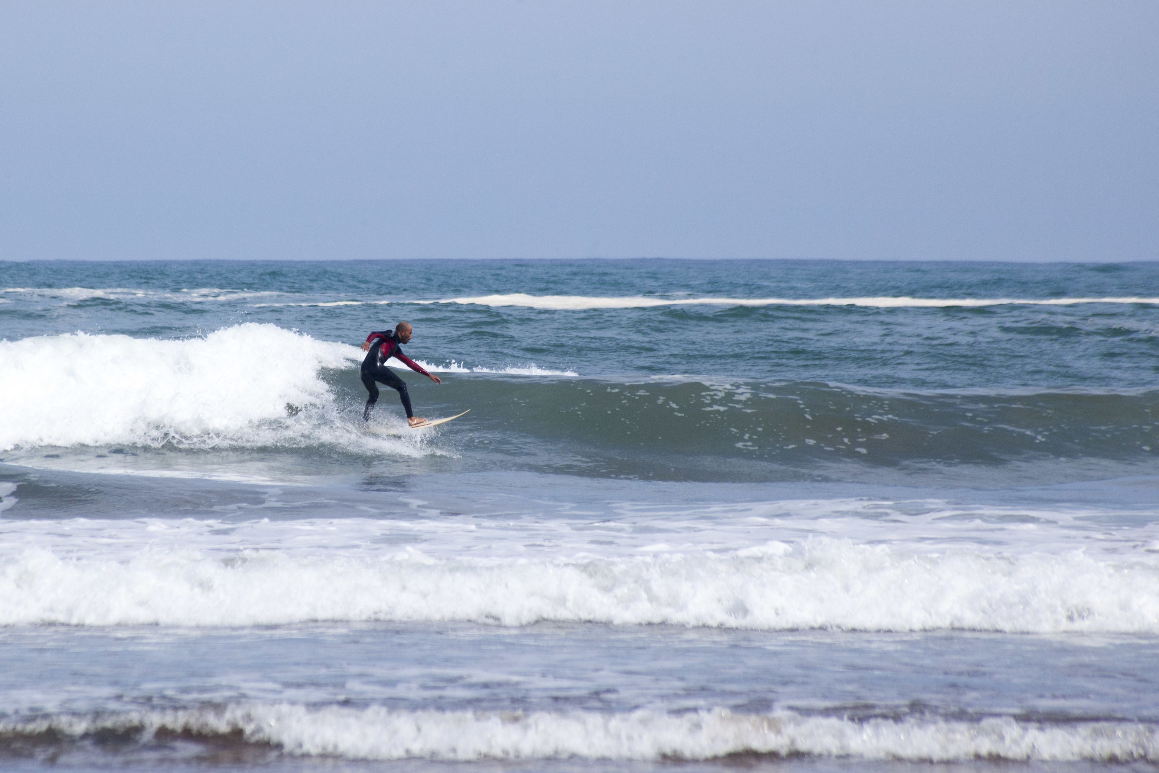 A surfer riding a wave in the ocean.