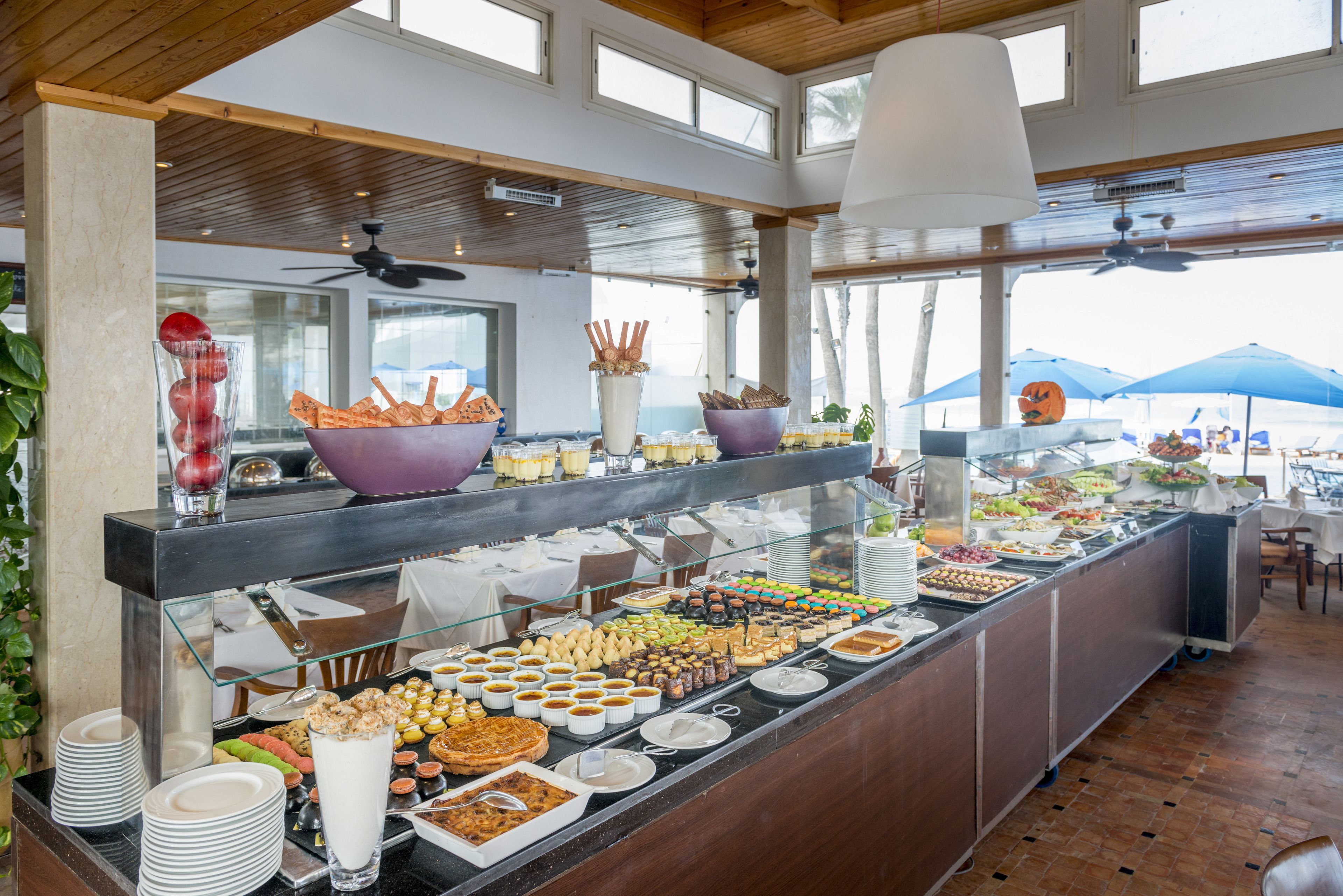 A buffet with various food items and a glass display case.