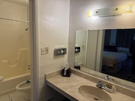 Room, 1 King Bed, Smoking | Bathroom | Combined shower/tub, free toiletries, hair dryer, towels