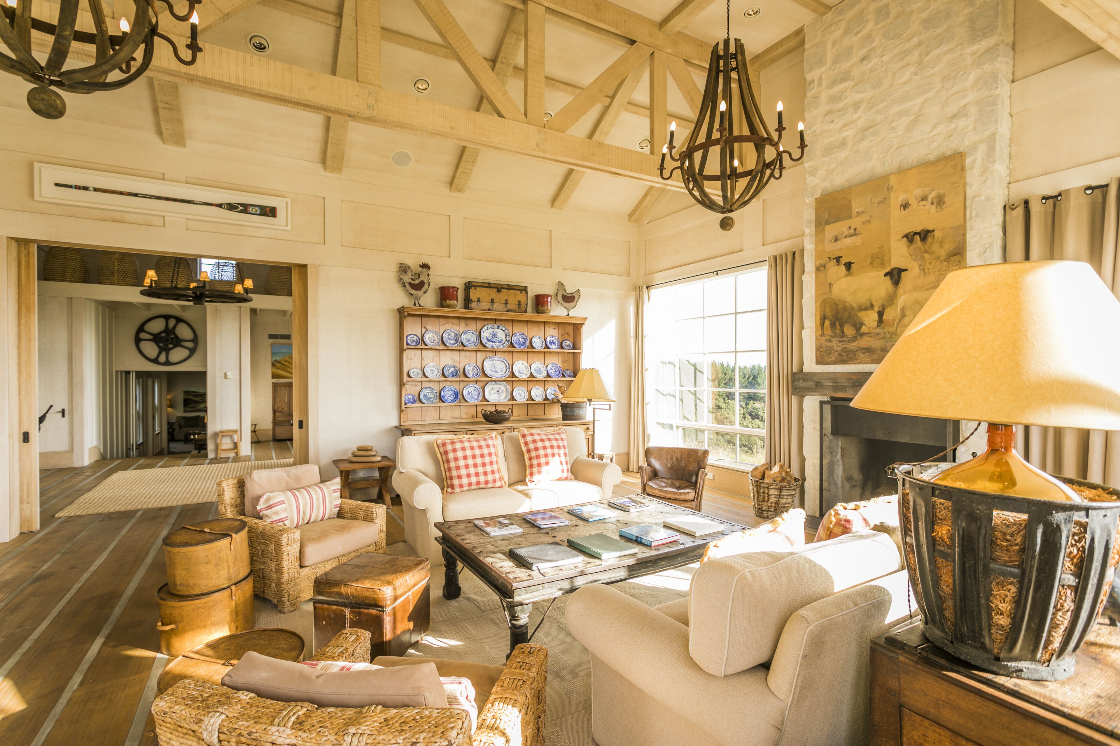 A cozy living room with a fireplace, a coffee table, and a bookshelf filled with books and decorative items.