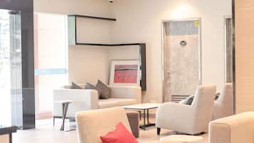 A modern lounge area with seating and a fireplace.