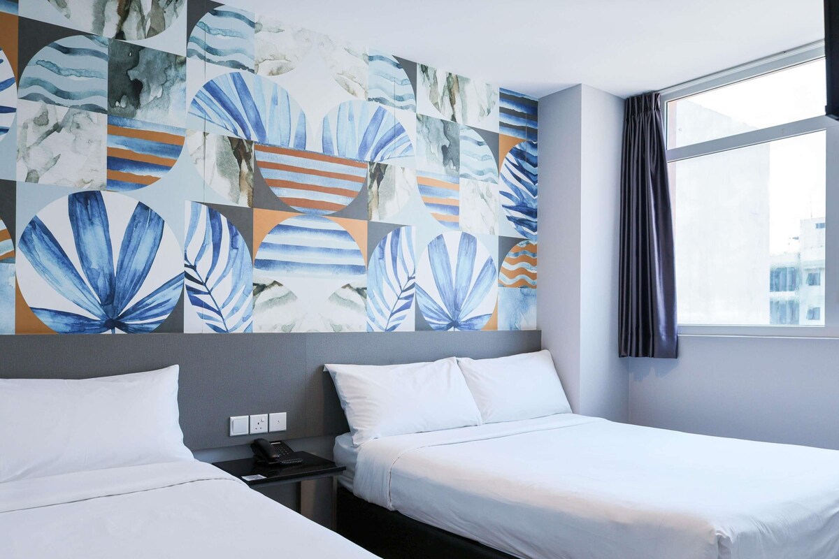 A hotel room with two beds, a nightstand, and a large abstract painting on the wall.