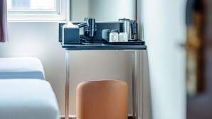 A modern bathroom with a glass sink, a towel rack, and a stool. - ibis budget Singapore Dahlia (Singapore)