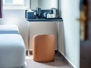 A modern bathroom with a glass sink, a towel rack, and a stool. - ibis budget Singapore Dahlia (Singapore)