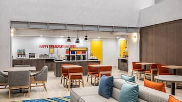 A modern breakfast area with seating and a counter.