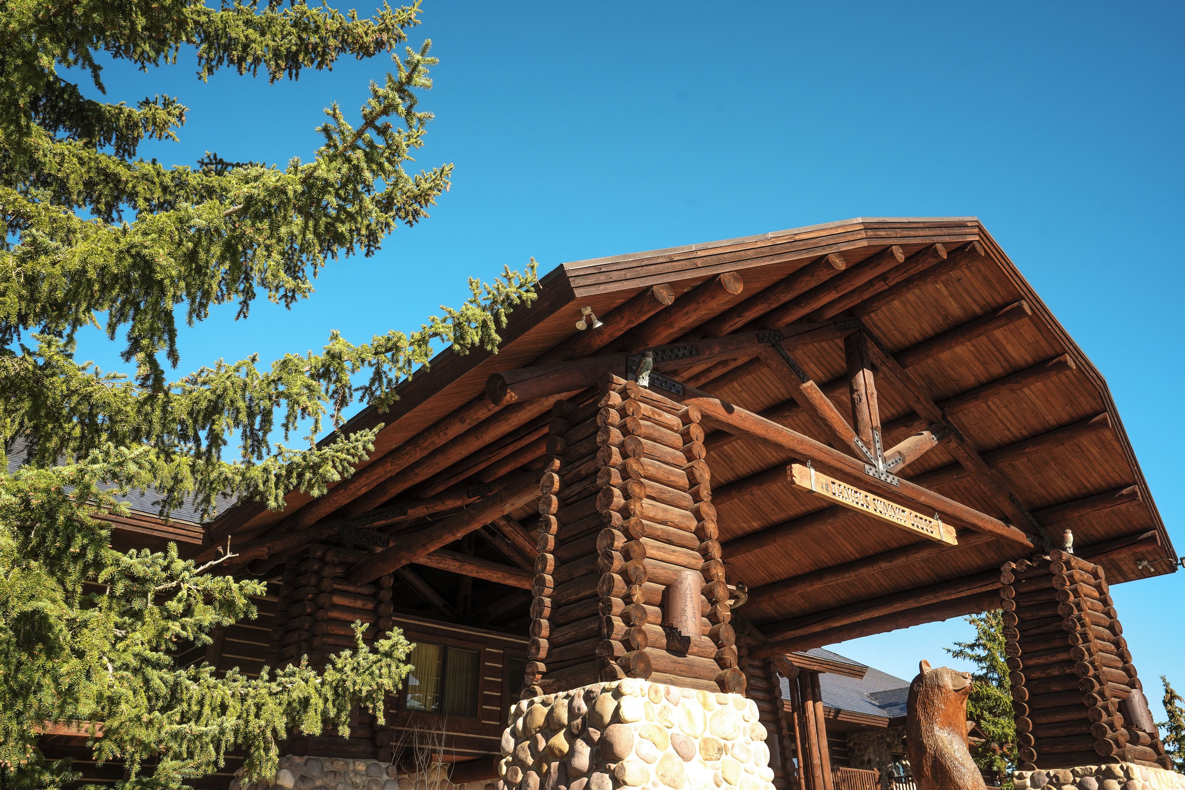 A log cabin with a stone foundation and a wooden roof.