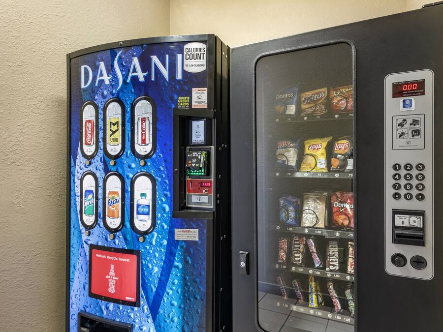 Two beverage vending machines with various drink options and a calorie counter.
