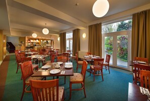 Enjoy meals in this inviting dining area with comfortable seating and a view of the outdoors.