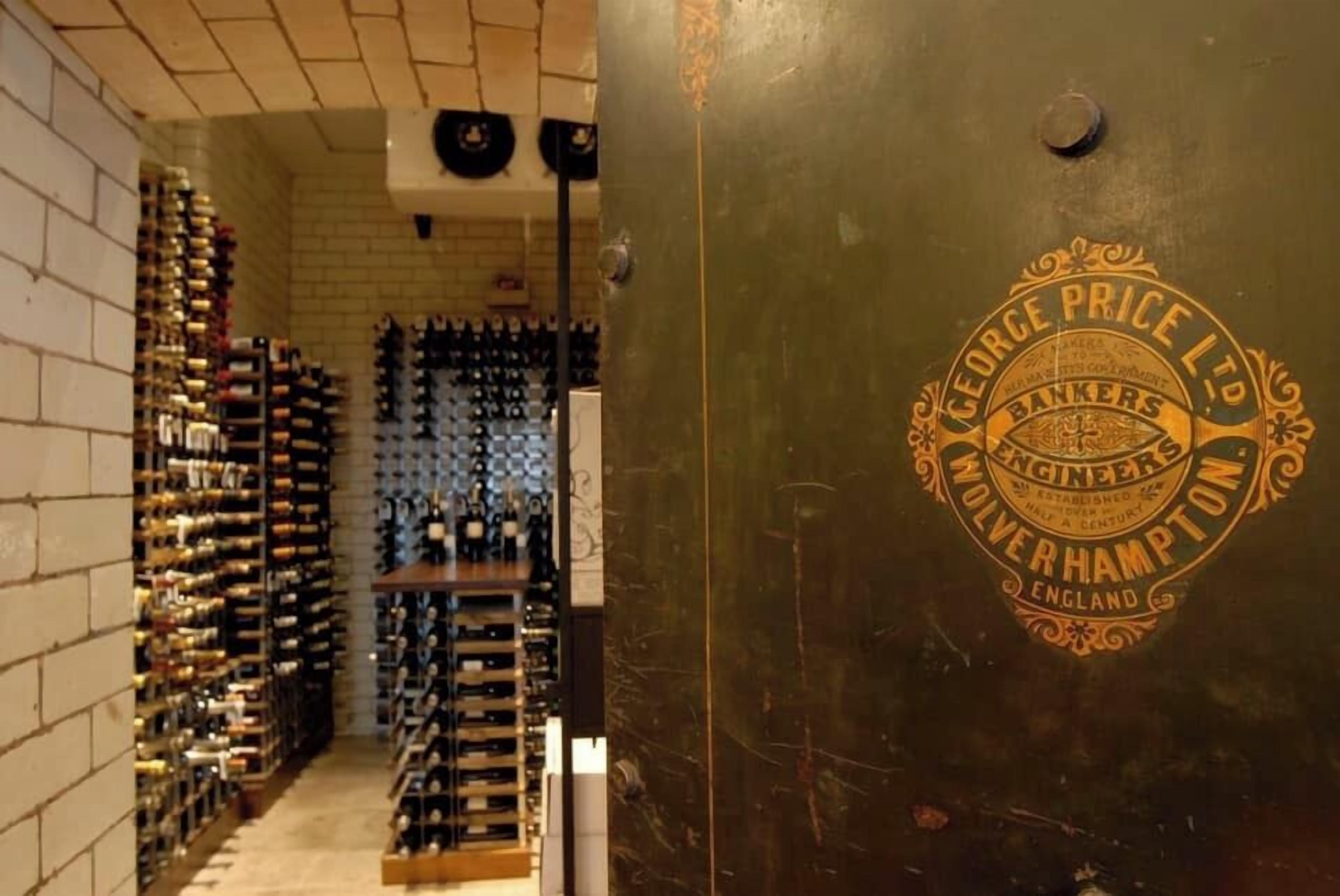 A wine cellar with rows of wine bottles on shelves.