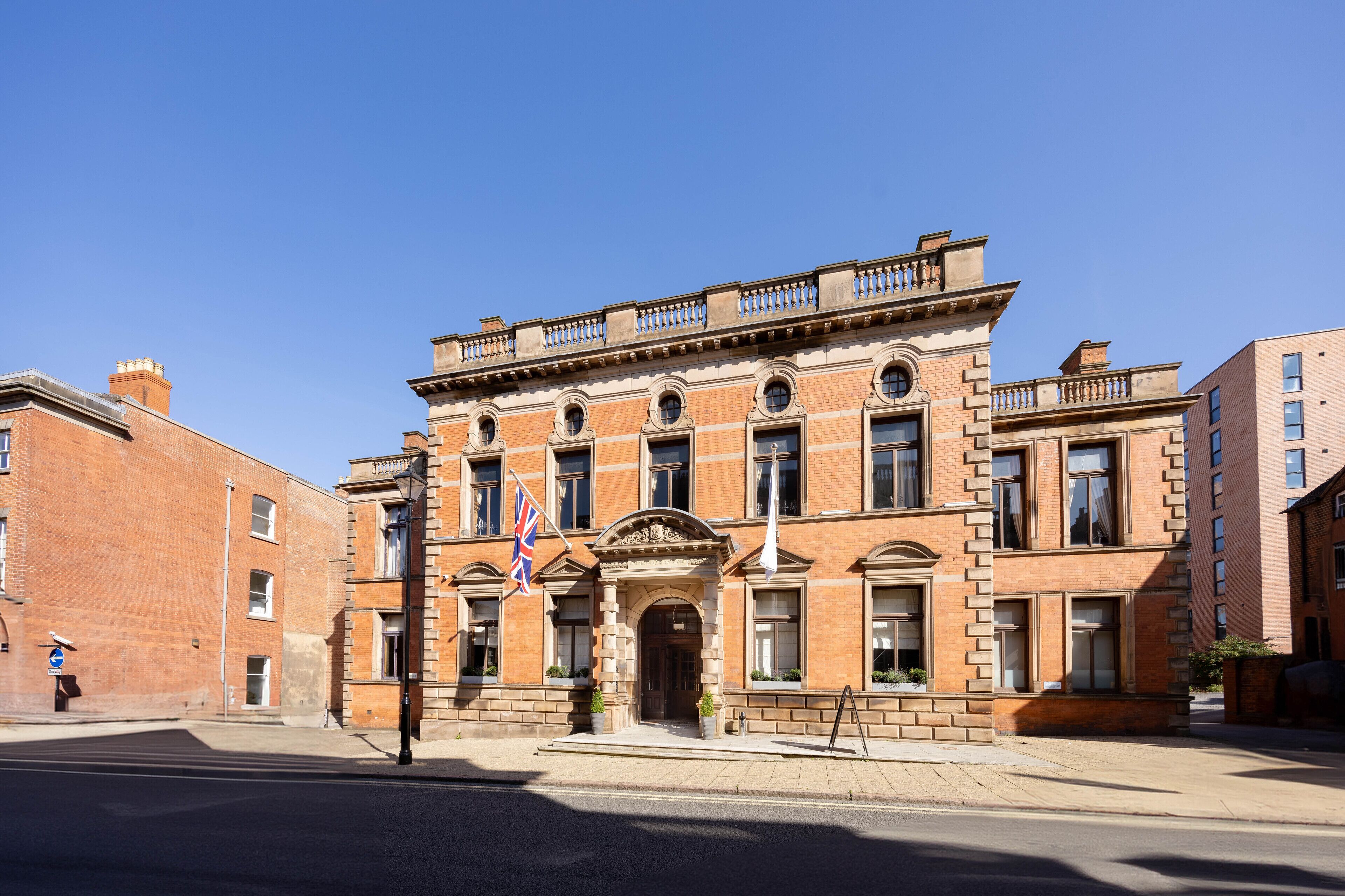 A historic building with a symmetrical facade, large windows, and a prominent entrance.