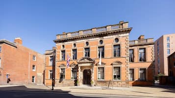 A historic building with a symmetrical facade, large windows, and a prominent entrance.