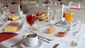 A breakfast setting with a variety of food items, including bread, cheese, and fruits, along with beverages like coffee and juice. - Famissi Eden Hotel (Kalabaka)