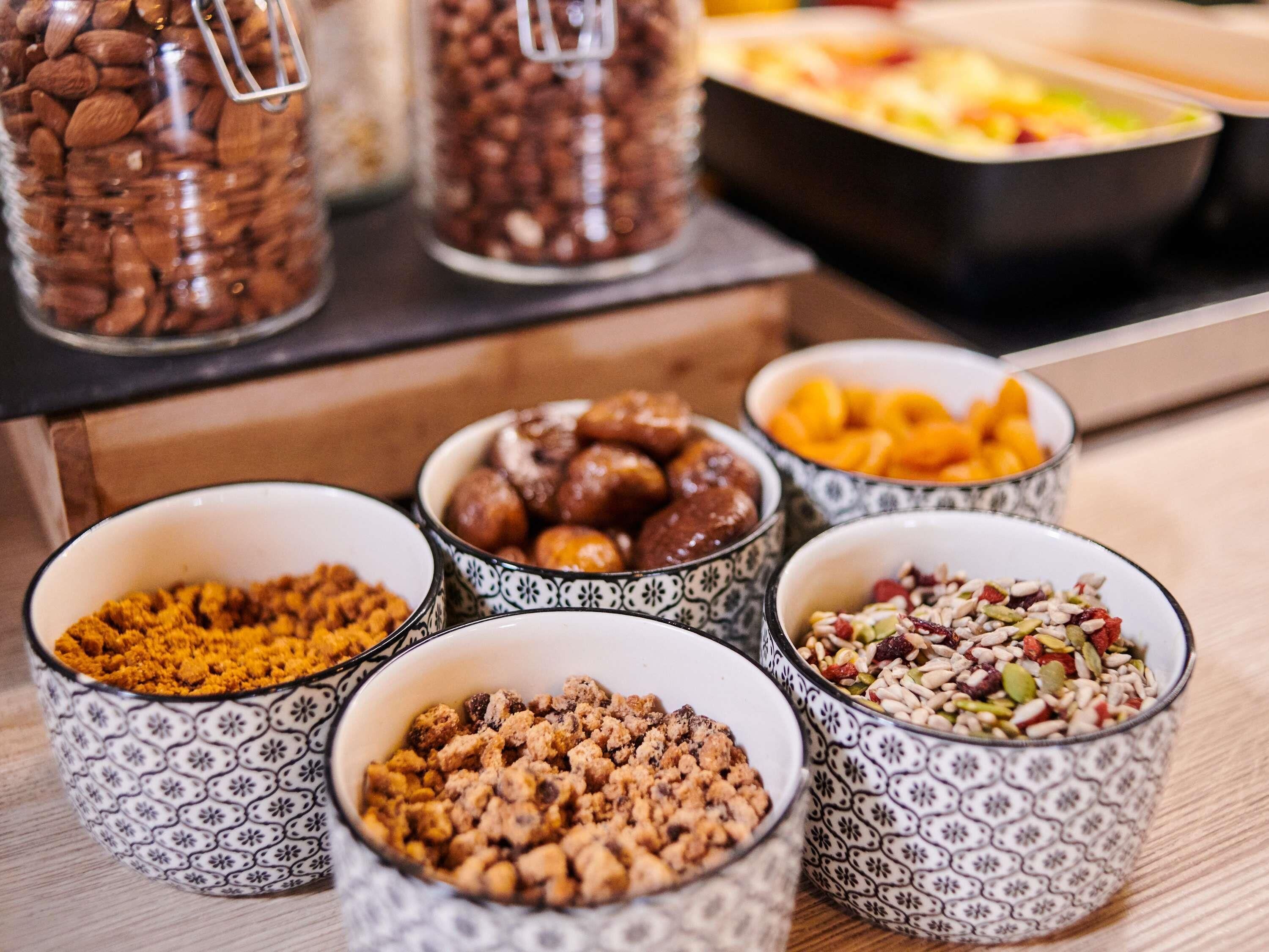 A variety of food items in patterned bowls on a table.