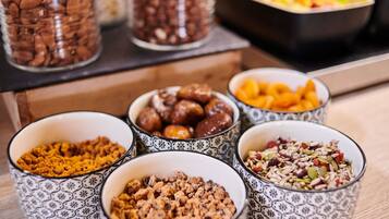 A variety of food items in patterned bowls on a table.