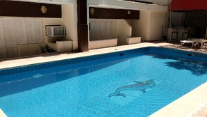 A swimming pool with a clear water surface, a tiled border, and a decorative fish pattern. - Indiana Hotel Cairo (Giza)
