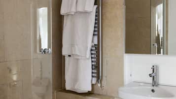 A bathroom with a sink, mirror, and towel rack.