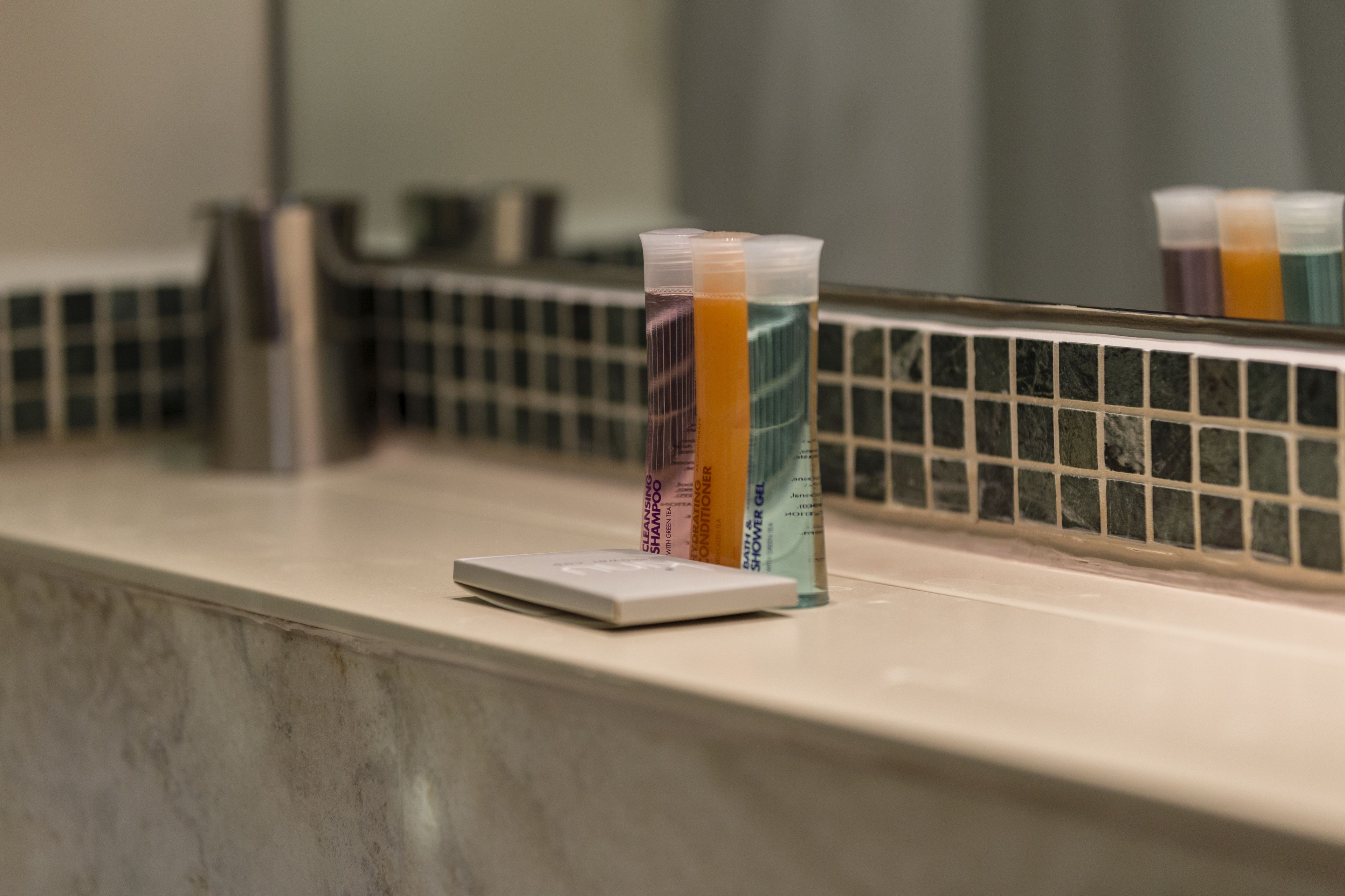 designer toiletries, hair dryer, towels