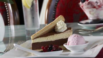 A dessert plate with a slice of cake and a scoop of ice cream.