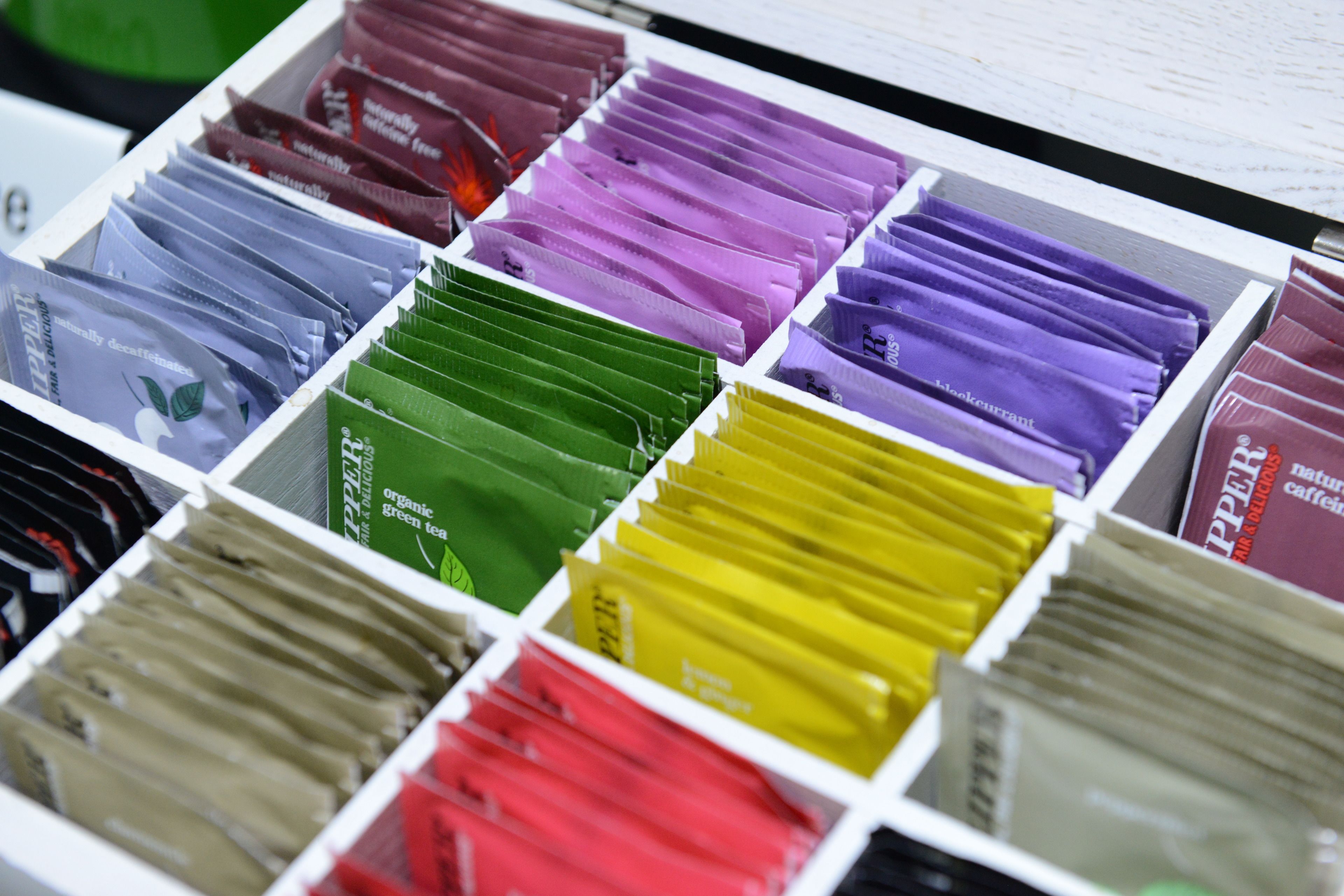 A neatly organized display of tea bags in various colors.