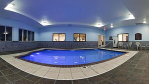 An indoor swimming pool with a curved design, surrounded by a tiled floor and walls. - Hyatt House Bentonville/Rogers (Rogers)