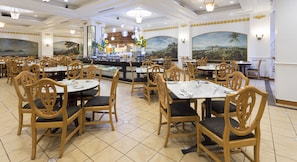 A restaurant with wooden chairs and tables, a bar area, and murals on the walls. - Bayview Hotel Georgetown Penang (George Town)