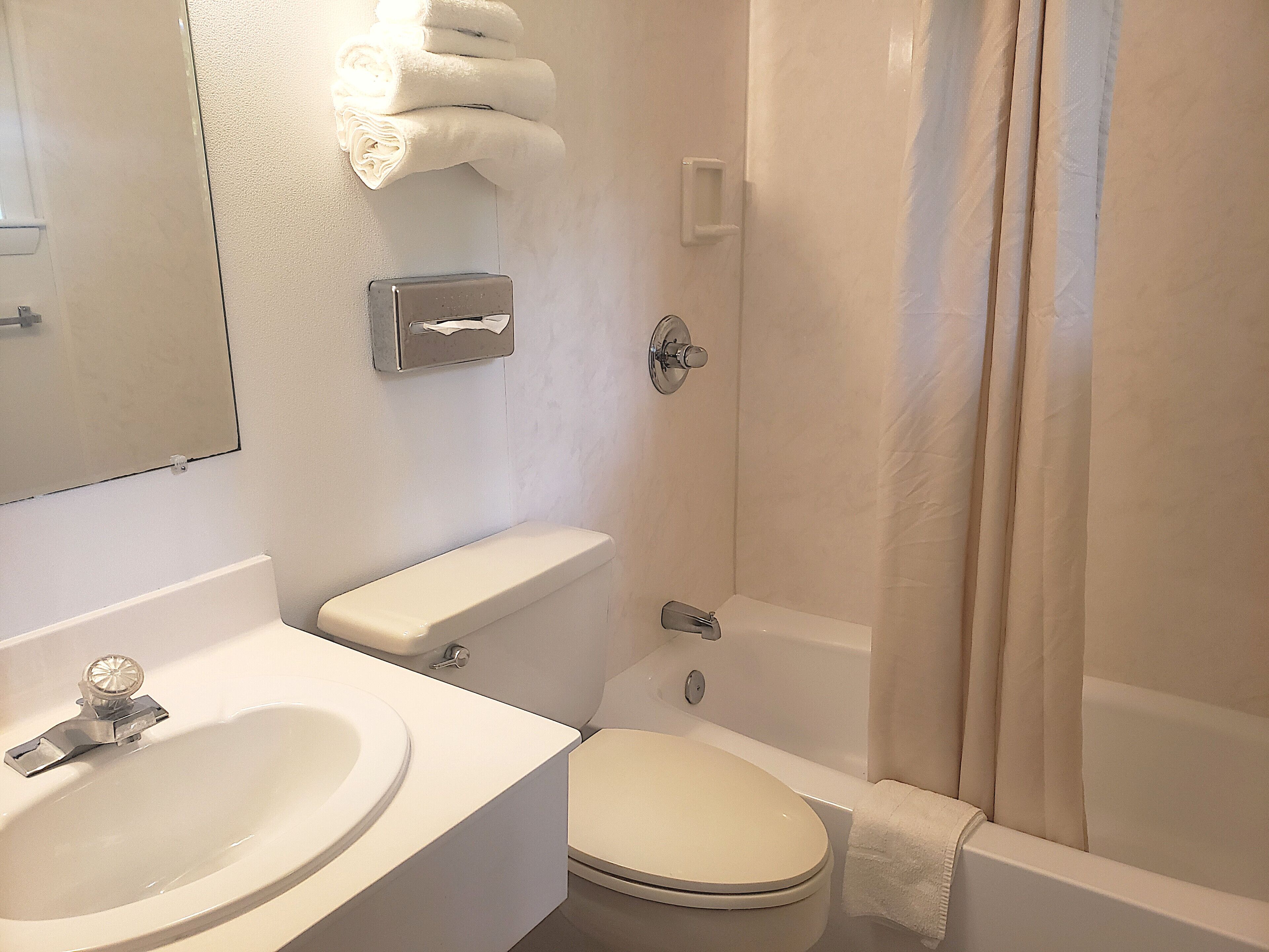 A bathroom with a sink, toilet, and bathtub.