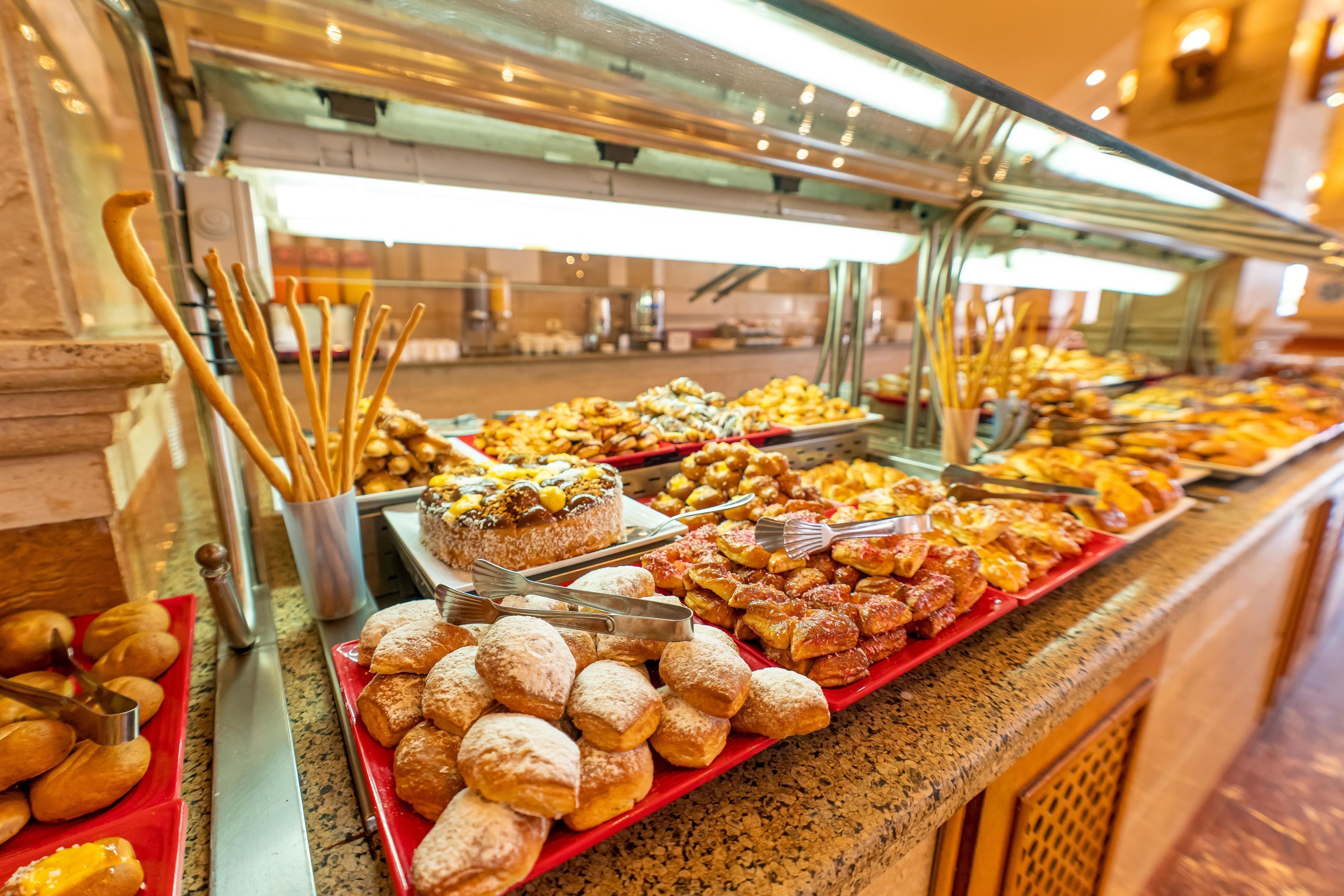 A buffet with various pastries and desserts.