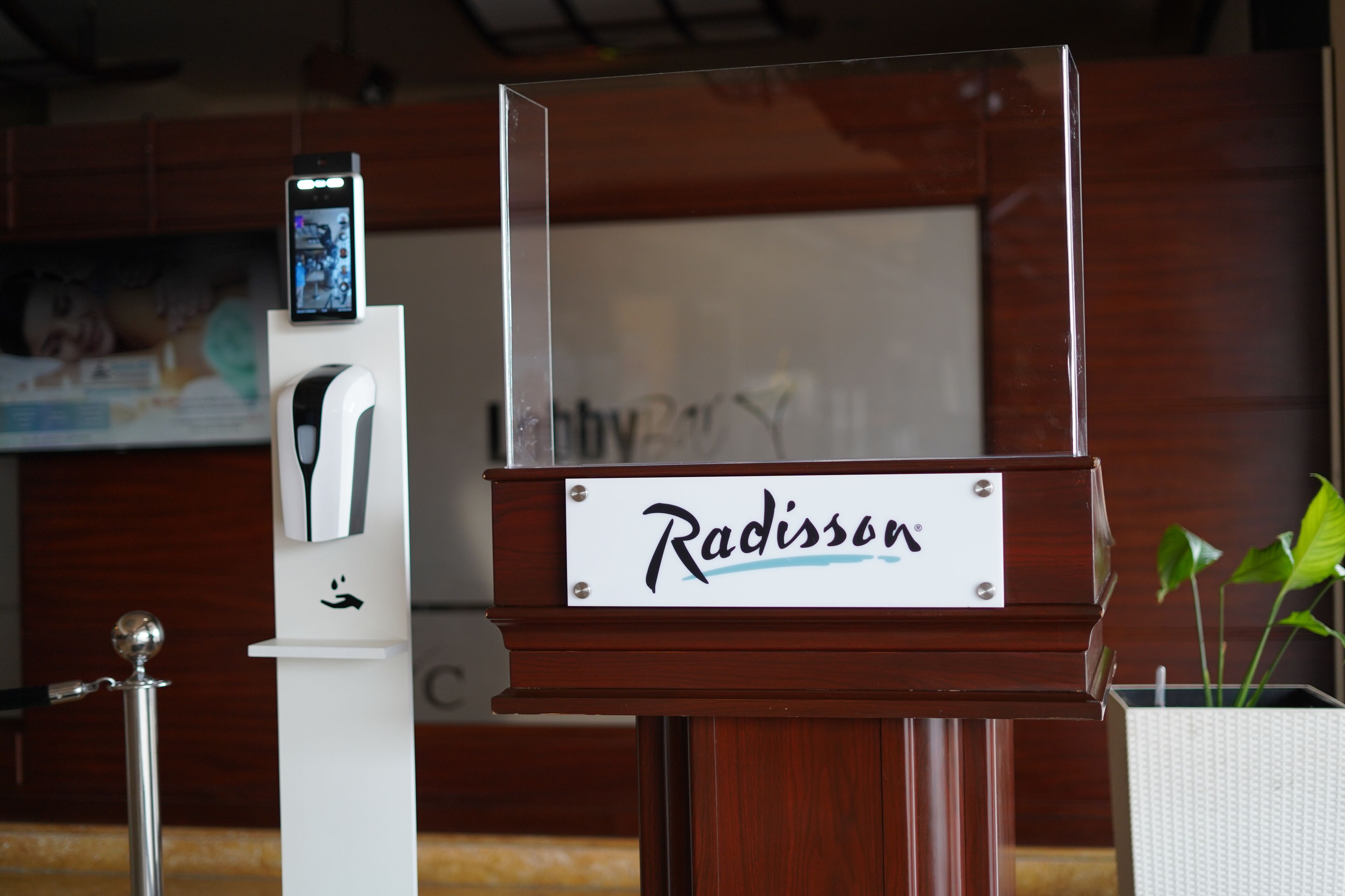 A wooden podium with a sign that reads "Radisson."
