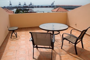 Enjoy a balcony with a round table and two chairs, offering a view of the nearby water.