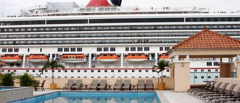 Outdoor pool, open 6 AM to 8 PM, pool loungers