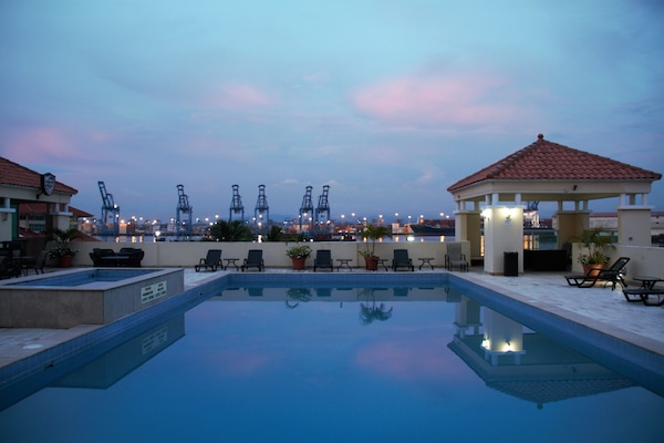 Outdoor pool, open 6 AM to 8 PM, pool loungers