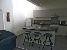 Microondas, placa de cocina, cafetera o tetera y utensilios de cocina