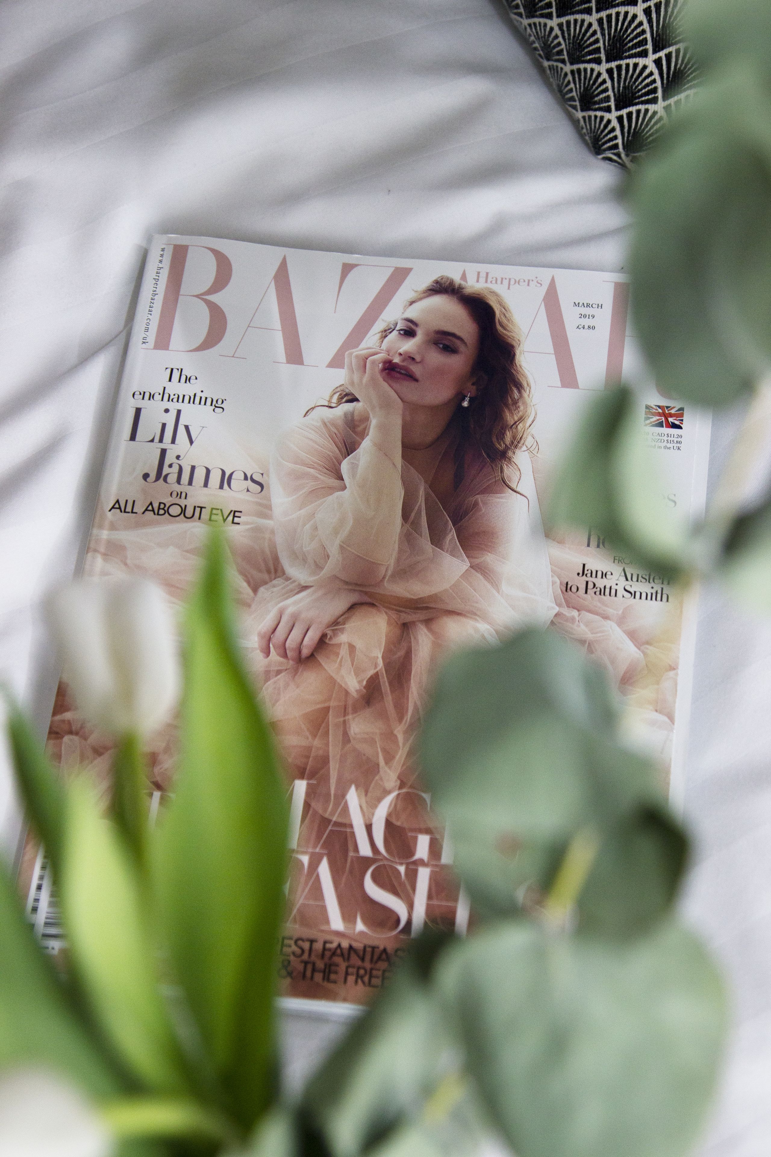 A magazine cover with a prominent title and a central image of a person in a dress.