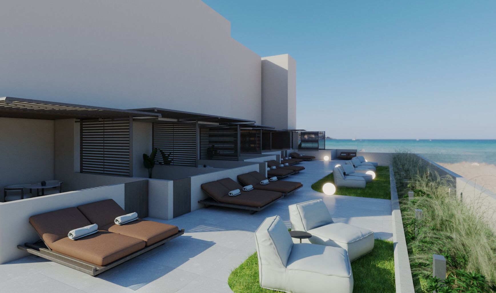 A rooftop lounge area with sun loungers and a view of the beach.