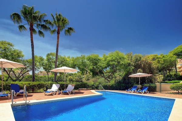 Piscine extérieure, parasols de plage, chaises longues