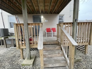 Relax on the upper deck with two comfortable chairs, overlooking the surrounding area.
