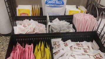 A storage area with various bags of food products, including Lipton tea, Swiss Miss milk chocolate, and other items.