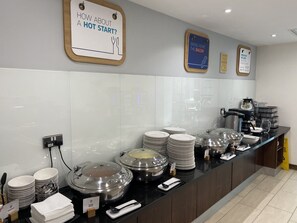 A buffet setup with multiple serving stations, including hot and cold food options, and a coffee station. - Holiday Inn Express Hotel Burnley M65 JCT10 by IHG (Burnley)